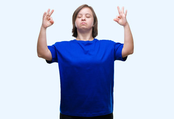 Sticker - Young adult woman with down syndrome over isolated background relax and smiling with eyes closed doing meditation gesture with fingers. Yoga concept.