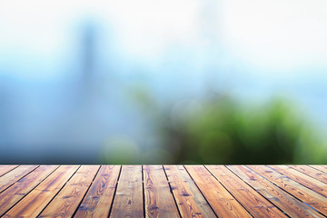 Wall Mural - City concept: Wood table top on blur glass window wall building background