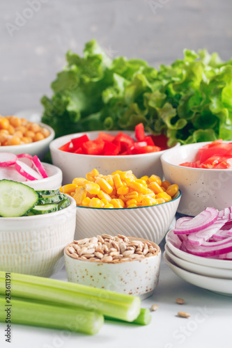 Fotografie, Obraz Assortment ingredients for healthy vegetarian salad in different portion bowls on a table