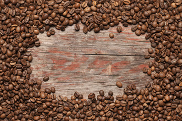 Poster - Pile of roasted coffee beans on wood