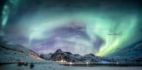 Wall Mural - northern lights explosion on snowy mountain range