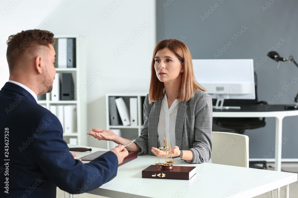 Male lawyer working with client in office