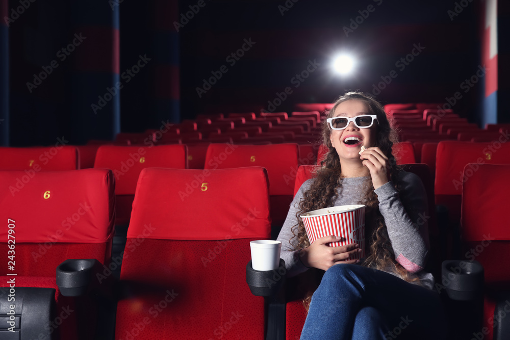 Young woman watching movie in cinema
