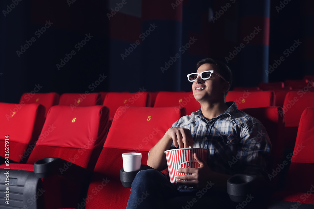 Young man watching movie in cinema