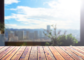 Wall Mural - city concept: wood table top on blur glass window wall building background