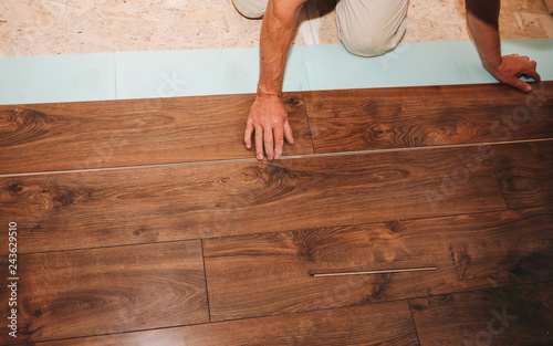 Worker Is Making Laminate Flooring In Apartment Maintenance