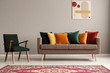© Photographee.eu - Vintage style living room with dark green retro armchair and comfortable sofa with pillows