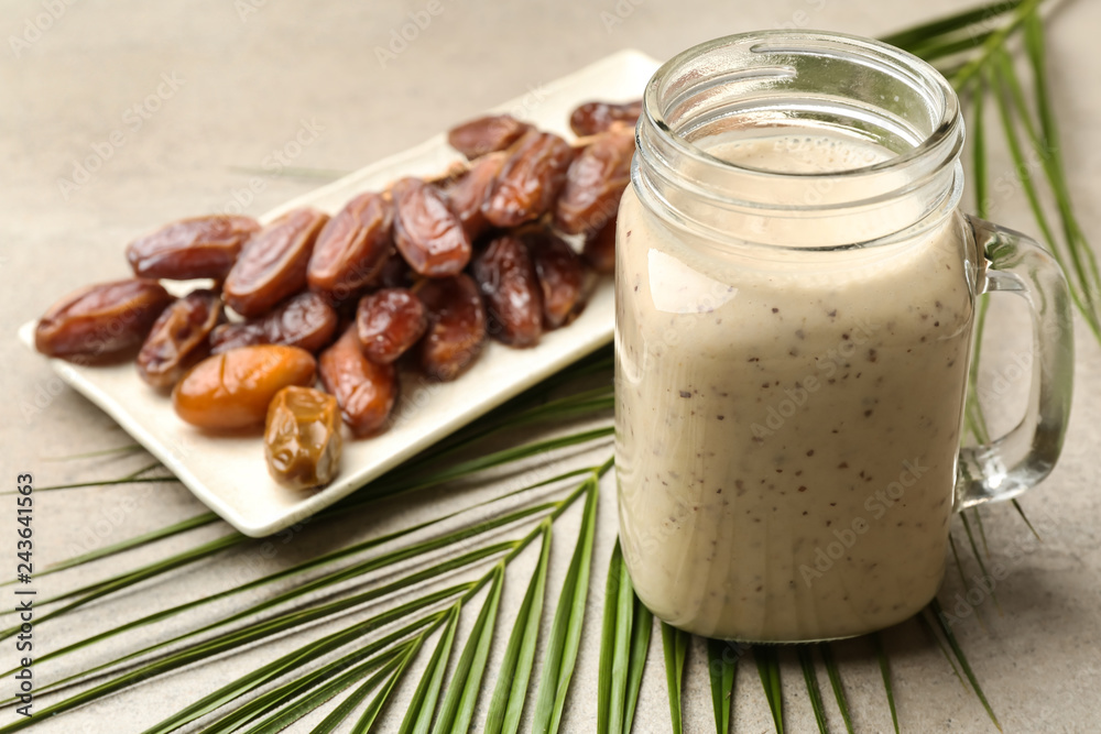 Mason jar of smoothie with dates on table