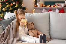 Cute Little Girl Drinking Hot Chocolate At Home On Christmas Eve