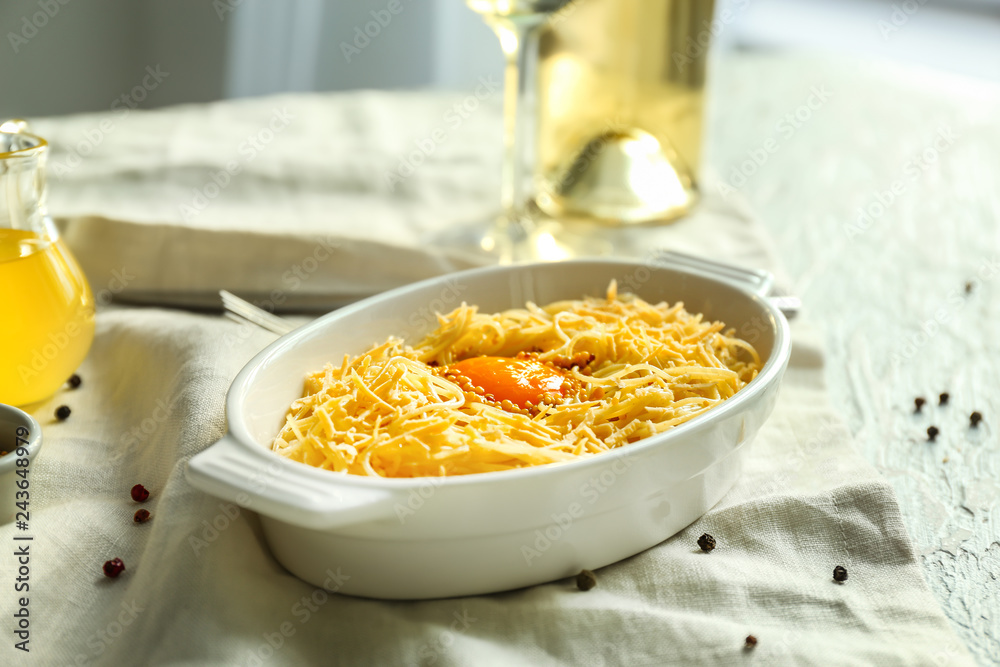 Dish with tasty pasta and egg on table