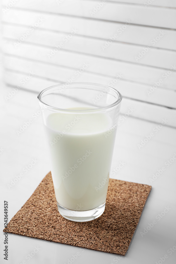 Glass of fresh milk on table