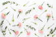 Pink carnation flowers on white background. Flat lay, top view, copy space.