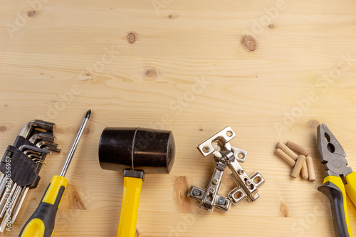 Fotografie, Tablou Furniture assembly components and tools arranged in a still life on a table