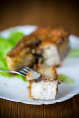 Wall Mural - piece of fried pike fish in a plate on a wooden