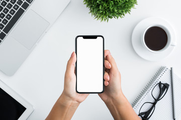 Poster - Hand using smartphone on white wooden background