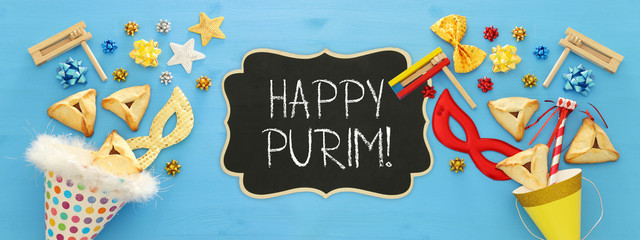 Purim celebration concept (jewish carnival holiday) over wooden blue background. Banner.