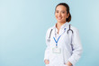 © Drobot Dean - Woman doctor posing isolated over blue wall background with stethoscope.