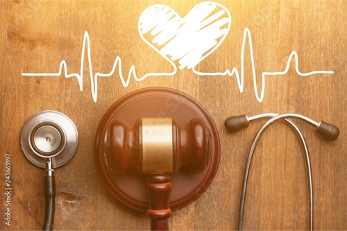 Cuadros en Lienzo Gavel and stethoscope on wooden background, symbol photo for