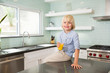 © Westend61 - Portrait of happy boy in kitchen with glass of orange juice