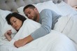 © wavebreak3 - Couple sleeping on bed in bedroom