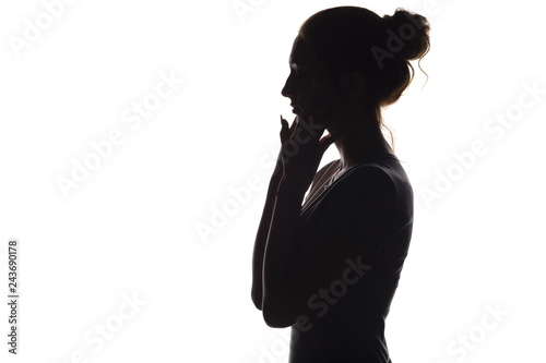 Fényképezés silhouette of a calm young woman on a white isolated background, figure of girl