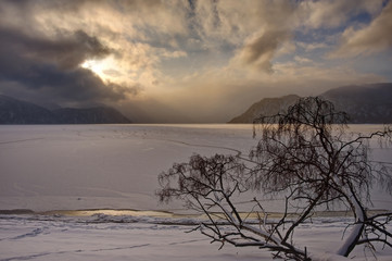 Sticker - Russia. Mountain Altai near the village Yaylu. Winter sunset on lake Teletskoye.