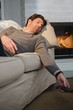 © WavebreakMediaMicro - Man sleeping on sofa while watching television in living room