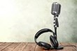 Retro style microphone and headphones on  background