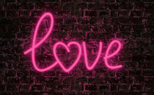Love Word Neon Text On Grunge Wall Background