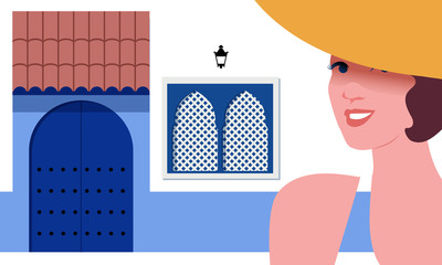 Wall Mural - Woman with yellow hat, on background of typical Mediterranean village Moorish style. Blue door under a roof, bluish zocalo and Moorish windows.