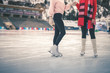 © petunyia - Unrecognizable teenagers girls ice skating outdoor at ice rink