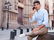 © caftor - modern guy walks in city and communicates on smartphone