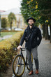 © F8  \ Suport Ukraine - Enjoying the urban lifestyle. Young bearded man while sitting on his bicycle outdoors