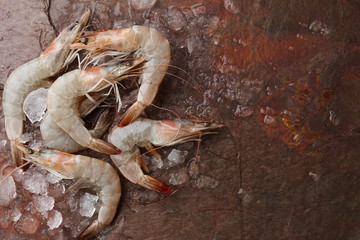 Wall Mural - Raw tiger prawns on stone background