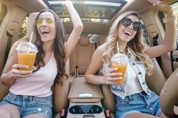 Poster - women holding cocktails in plastic cups