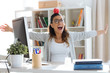 © nenetus - Happy young business woman having fun and holding red apple over her head in the office.
