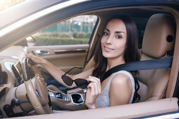 Wall Mural - woman at the looking camera in the car