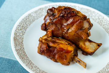 Two pieces of grilled pork knee.