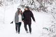 © Aleksandr - Happy young couple in winter park laughing and having fun. Family outdoors