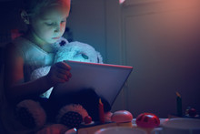 Little Girl With Toy Bear Browsing Tablet