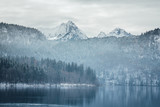 Fototapeta Góry - Amazing winter landscape of alpine lake with crystal clear water and mountains in background