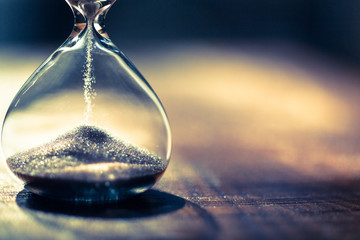 hourglass as time passing concept for business deadline, urgency and running out of time. sandglass,