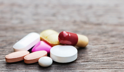 Pills or medicine on wood table. The drug is needed to treat the disease.