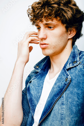 Fotografie, Obraz Portrait of a smart serious young man standing against white bac