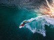 Bodyboard surfer rides tropical wave at sunset