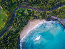 Aerial View Of The Sandy Beach And Curved Asphalt Road On The West Coast Of Maui. Hawaii