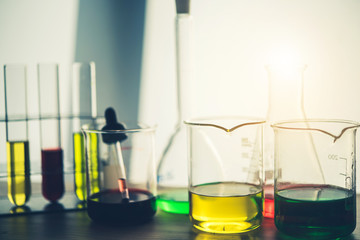 Wall Mural - laboratory glassware containing colorful chemical liquid, lab research and development concept