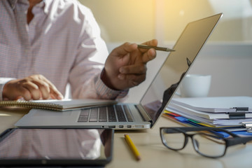 Poster - double exposure of business man hand working on laptop computer on wooden desk with social media network diagram