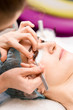© Aidman - European beautiful woman is getting treatment laminating procedure for her eyelashes in beauty and wellness saloon