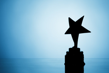 Wall Mural - star trophy silhouette, blue background